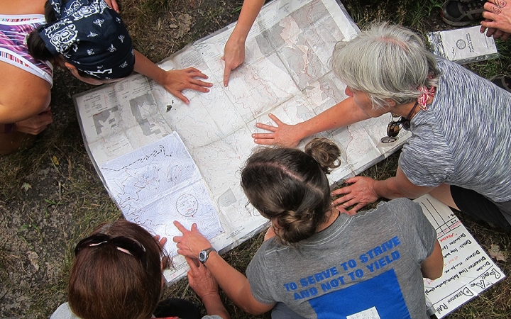 adults learn navigation skills on backpacking trip